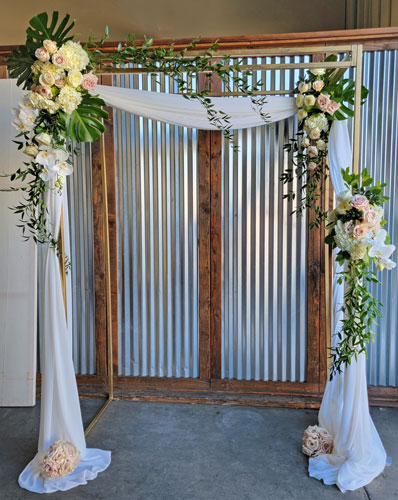 Wedding Arch with Chiffon, roses, orchids and hydrangea.